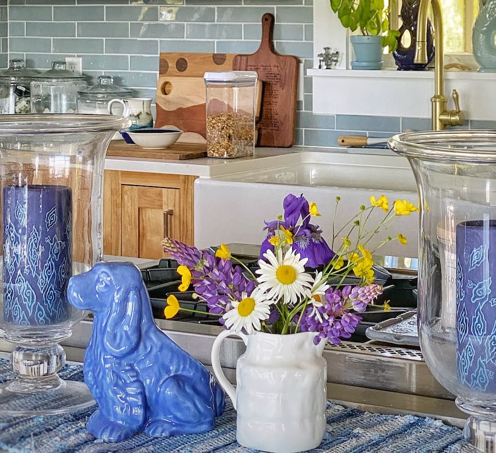 A vase of wildflowers in a kitchen