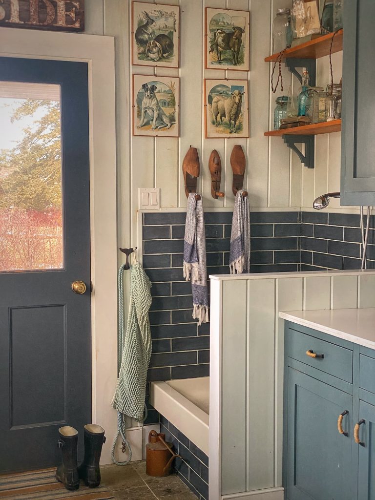 Mudroom view dog shower, blue tile and cabinets