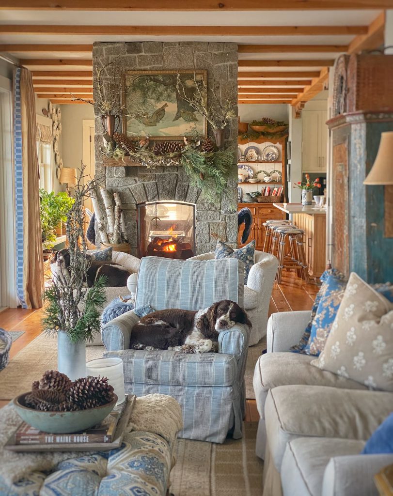 Cozy Maine living room with stone fireplace and blue and tan fabrics