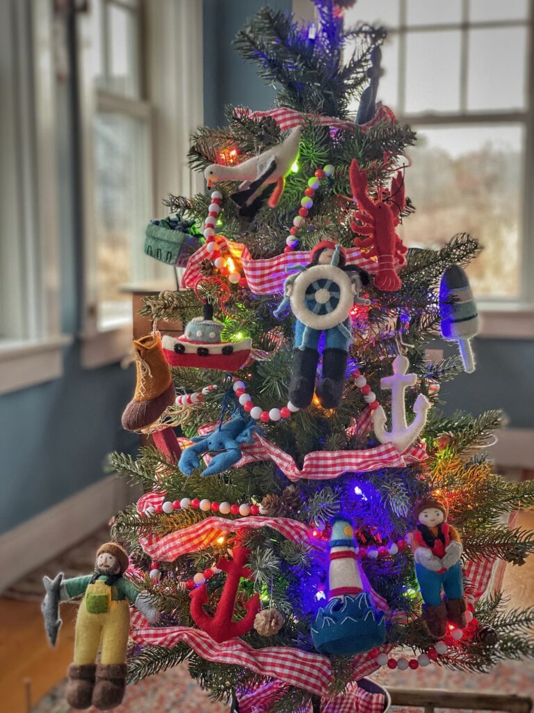 A close-up of my small Maine Christmas tree, decorated with handmade felt ornaments inspired by the sea — lobsters, seagulls, and lighthouses.